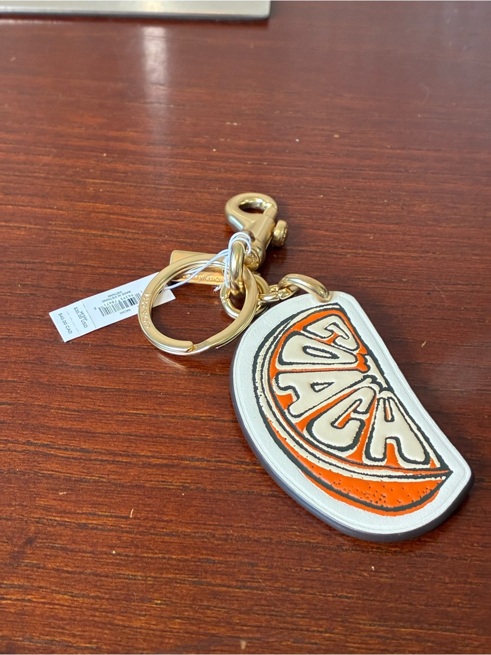 Coach Orange and White Leather Citrus Keychain with Gold Hardware